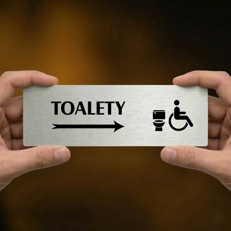 Toalety vpravo invalida, 240x79mm, zlatá popiska s okrasným rámečkem  