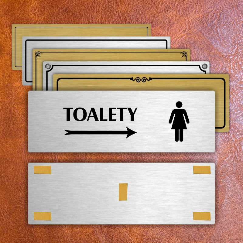 Toalety vpravo ženy, 240x79mm, stříbrná popiska s dvojtým rámečkem