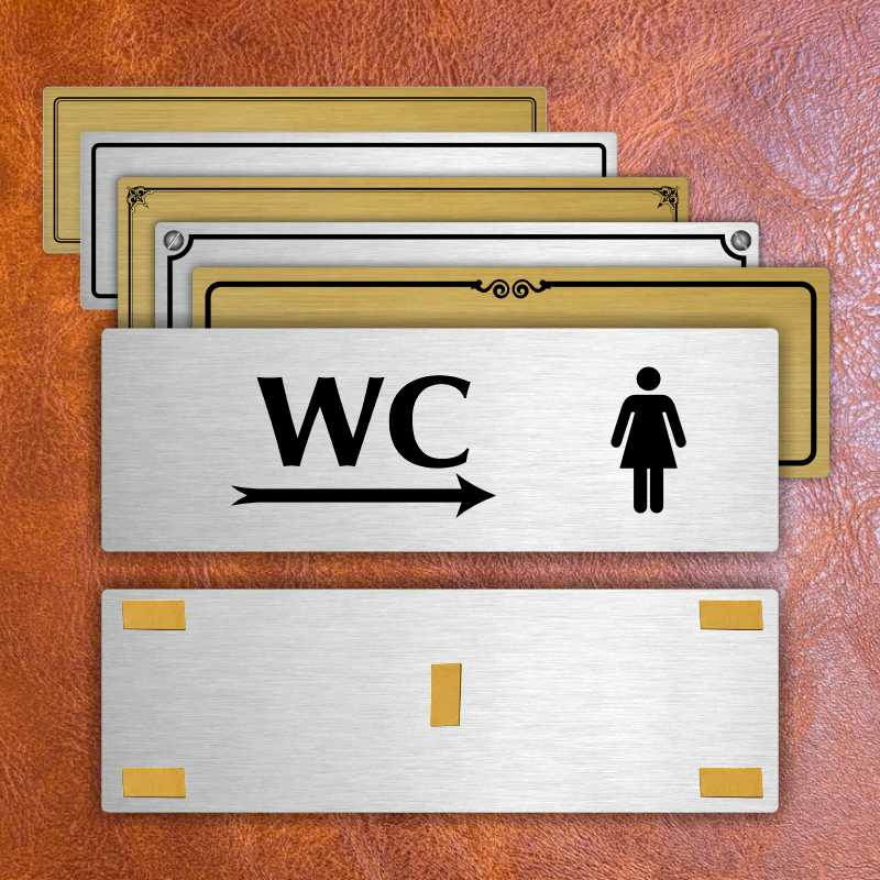 WC ženy vpravo, 240x79mm, zlatá popiska s ozdobou uprostřed