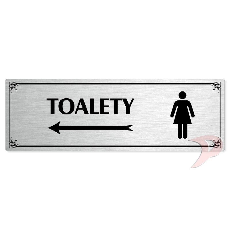 Toalety vlevo ženy, 240x79mm, stříbrná popiska s okrasným rámečkem