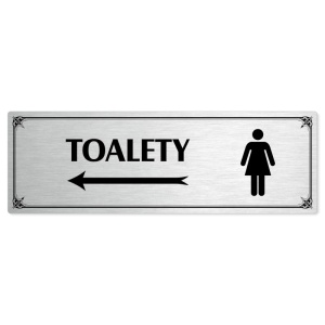 Toalety vlevo ženy, 240x79mm, stříbrná popiska s okrasným rámečkem  